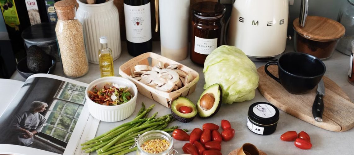 A variety of fresh ingredients and kitchen tools for preparing a healthy meal.